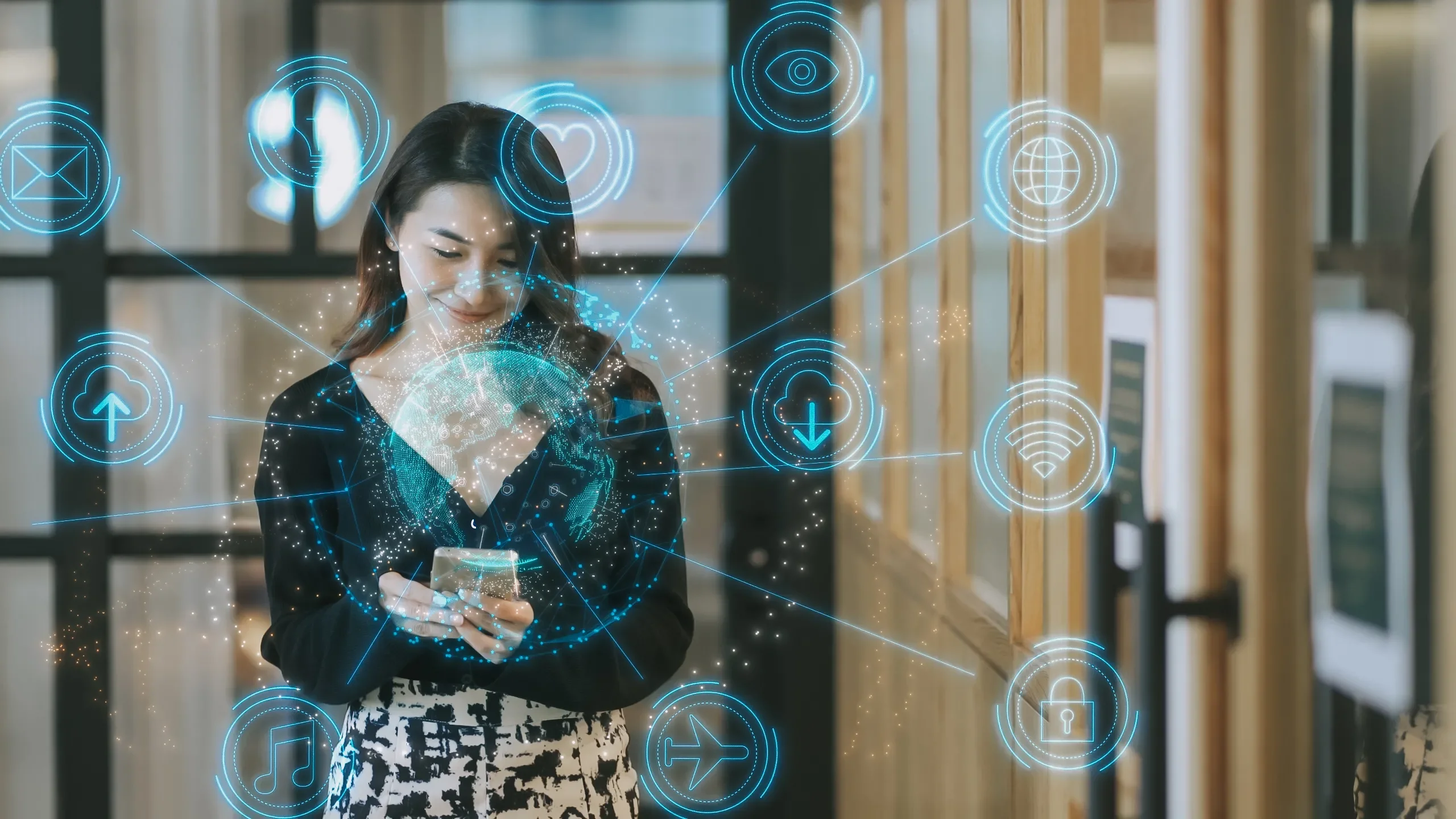 Woman standing with phone surrounded by blue digital icons