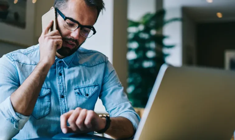 Man on phone while looking at watch