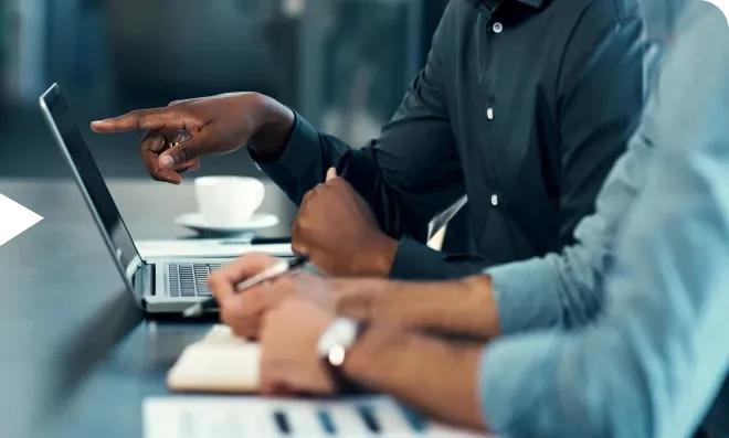 Hands pointing at computer screen