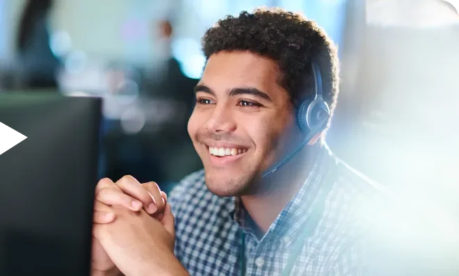 Man smiling and looking at computer