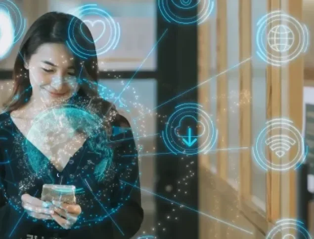 Woman standing with phone surrounded by blue digital icons